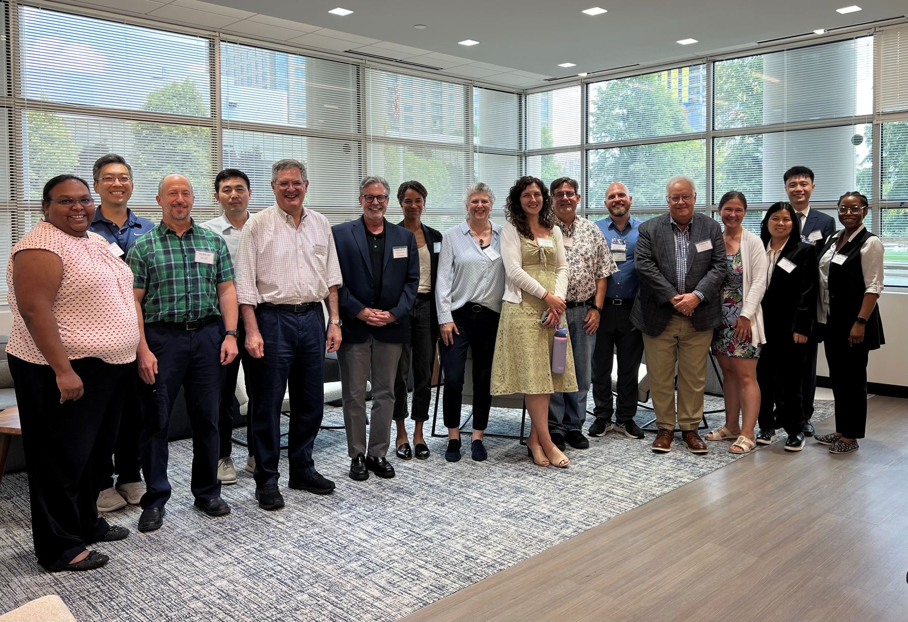 Members of the Accelerate BASSO Network at the 2025 in-person network meeting, standing together in a meeting room.